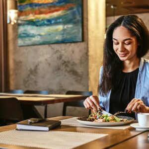 All happiness depends on a leisurely breakfast. Businesswoman having lunch in company's