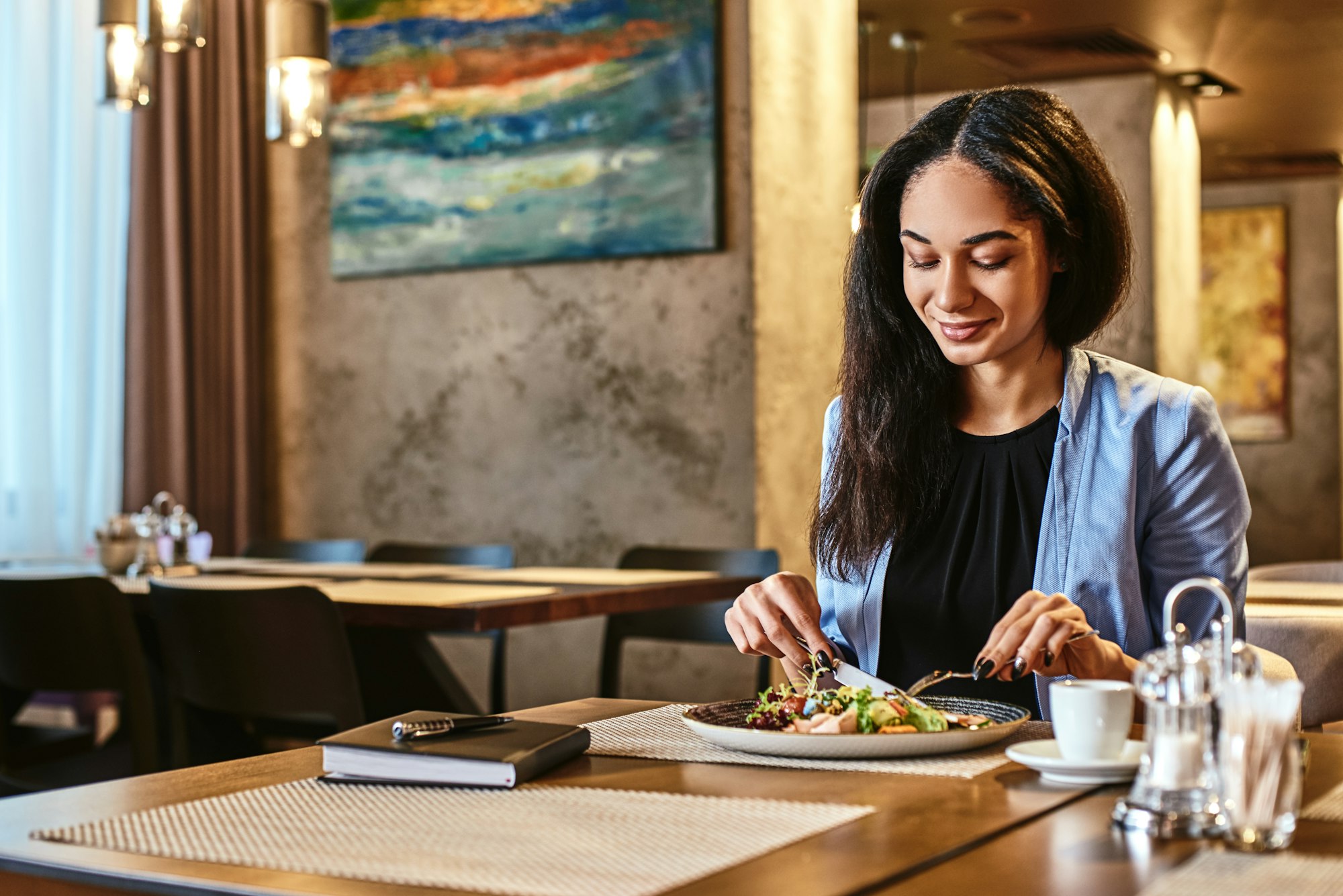 All happiness depends on a leisurely breakfast. Businesswoman having lunch in company's