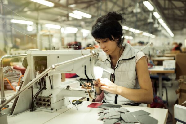 Worker in textile industry sewing